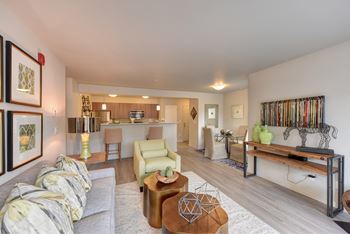 Model living room with view of kitchen